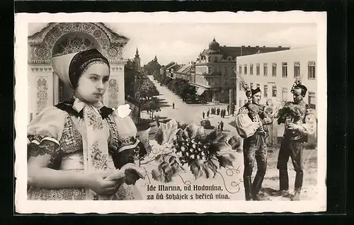 AK Göding, Strassenpartie, Männer und junge Frau in Tracht