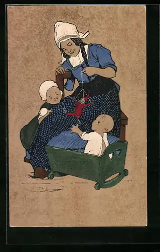 Künstler-AK Junge Mutter im niederländischen Trachtenkleid ihren Nachwuchs zu Bett bringend