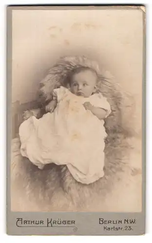 Fotografie Arthur Krüger, Berlin-NW, Karlstr. 23, Süsses Kleinkind im Kleid sitzt auf Fell