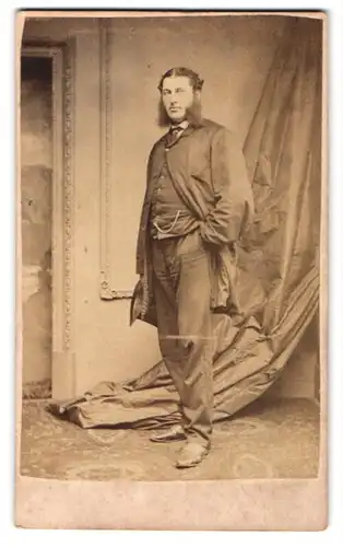 Fotografie H. J. Whitlock, Birmingham, 11. New Street, Stehender Mann mit drapiertem Vorhang im Hintergrund