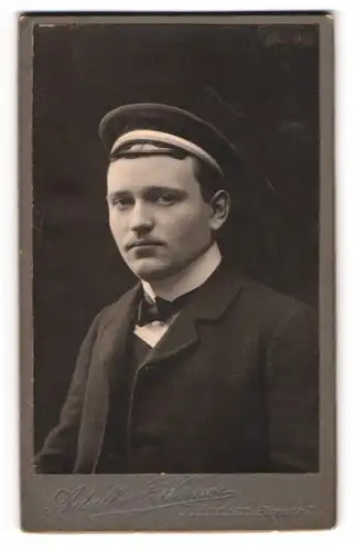 Fotografie Adalbert Werner, München, Elsienstr. 7, junger Student im dunklen Anzug mit Schirmmütze, 1906