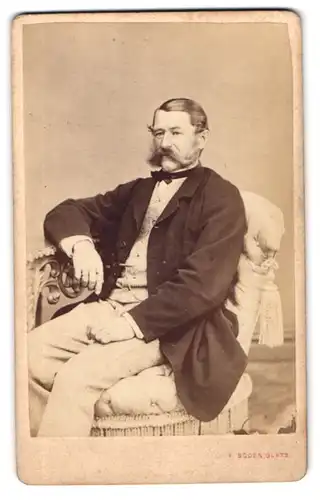 Fotografie Franz Boden, Glatz, Portrait älterer Herr im Anzug mit Fliege und gepflegtem Schnauzbart