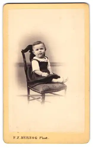 Fotografie F. X. Herzog, Loerrach, kleines Mädchen im Kleid auf Stuhl sitzend