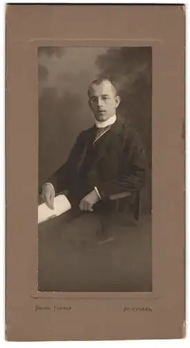 Fotografie Georg Tunnat, Stuttgart, junger Mann im Anzug mit Zwickerbrille