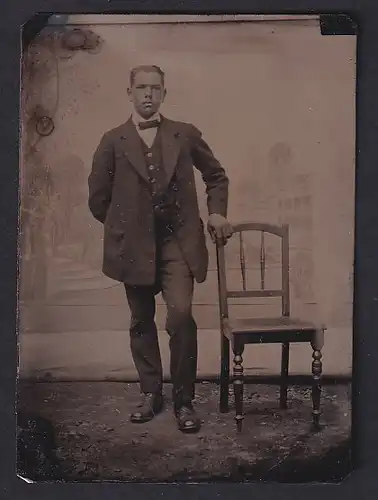 Fotografie Ferrotypie junger Herr im feinen Anzug an Stuhl lehnend