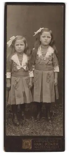 Fotografie Karl Küker, Ahlden a. d .Aller, zwei niedliche Mädchen in den selben Kleidern mit Haarschleife, Perlenkette
