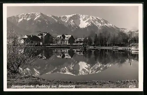 AK Puchberg, Ortsansicht mit Schneeberg im Wasser spiegelnd