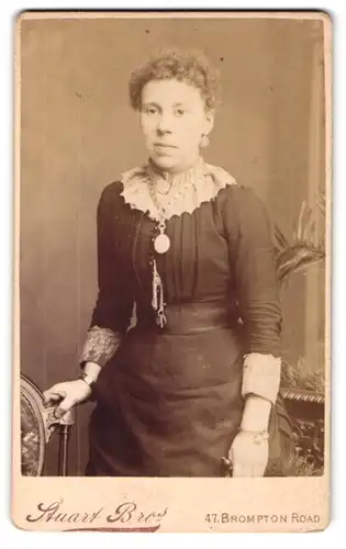 Fotografie W. & J. Stuart, London, 47, Brompton Road, Junge Dame im Kleid mit Amulett