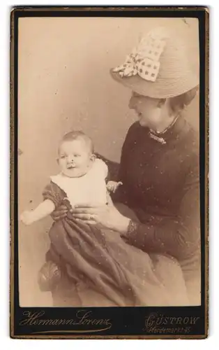 Fotografie Herrmann Lorenz, Güstrow, Pferdemarkt 45, Mutter im Sommerkleid mit Kind im Arm, Mutterglück