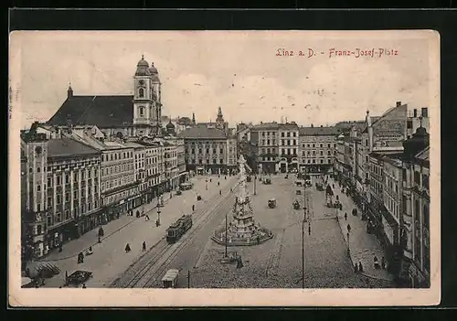 AK Linz a. D., Franz Josef-Platz mit Geschäften und Denkmal, Strassenbahn