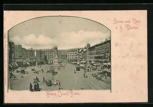 AK Linz a. d. Donau, Franz Josef-Platz mit Geschäften und Denkmal, Strassenbahn