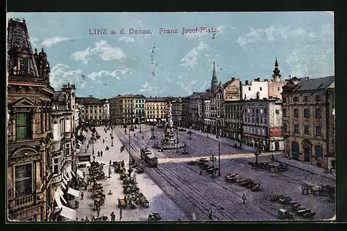 AK Linz a. d. Donau, Franz Josef-Platz mit Geschäften und Denkmal, Strassenbahn