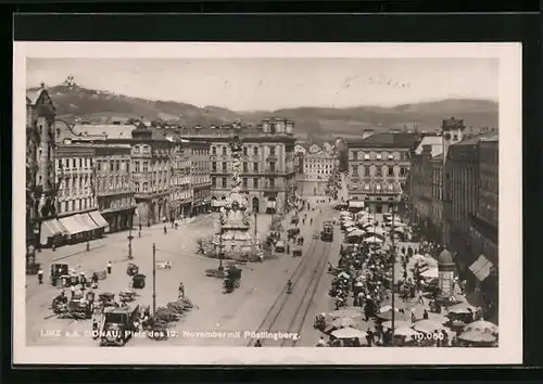 AK Linz a. d. Donau, Platz d. 12. November mit Denkmal und Strassenbahn, Pöstlingberg