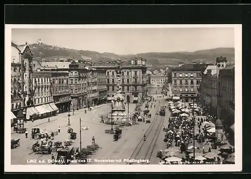 AK Linz a. d. Donau, Platz d. 12. November mit Denkmal und Strassenbahn, Pöstlingberg