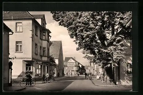 AK Ruhland, Dresdner Strasse mit Geschäften und Radfahrer