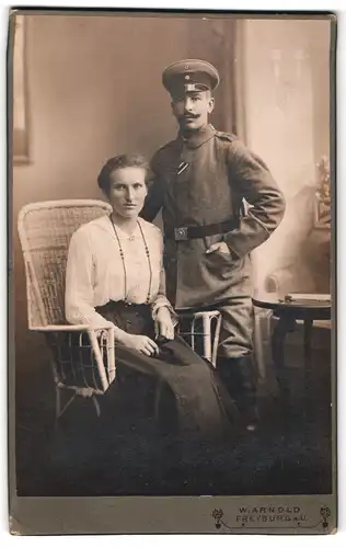 Fotografie W. Arnold, Freyburg a. U., Schützenstr. 7, Soldat in Feldgrau mit Schirmmütze gemeinsam mit der Gattin