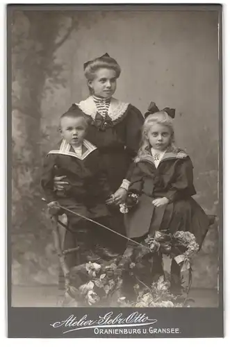 Fotografie Gebr. Otto, Oranienburg, Junge Dame im Kleid mit kleinem Jungen und Mädchen