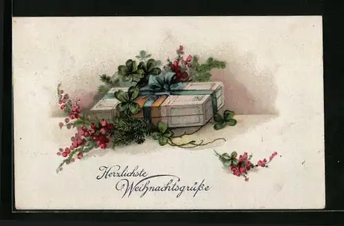Künstler-AK Herzlichste Weihnachtsgrüsse, Geschenk mit Schleife und Kleeblättern
