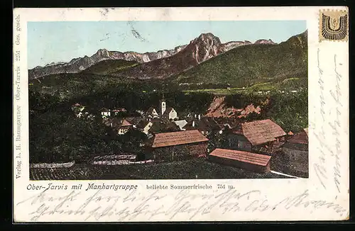 AK Ober-Tarvis, Ortsansicht mit Manhartgruppe, Häuser mit leuchtenden Fenstern und leuchtenden Bergspitzen