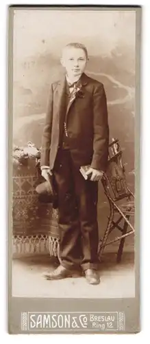 Fotografie Samson & Co., Breslau, Ring 12, junger Knabe im Anzug mit Hut und Bibel in der Hand, Kommunion