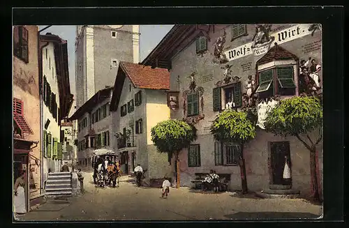 AK Kastelruth, Strassenpartie mit Gasthaus Wolf-Wirt