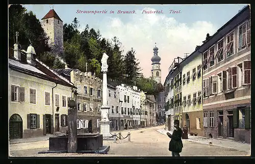 AK Bruneck, Strassenpartie mit Brunnen, Denkmal und Kirche