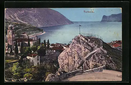 AK Torbole, Ortsansicht mit Felsen und See