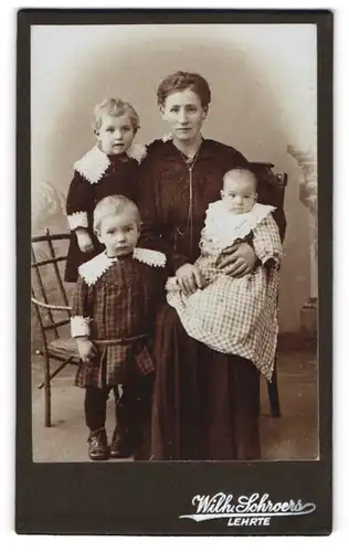 Fotografie Wilh. Schroers, Lehrte, Mutter neben ihren drei Kindern mit Spitzenkragen, Mutterglück