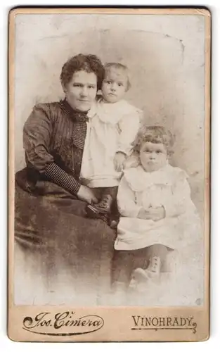 Fotografie Jos. Cinera, Praha, Mutter neben ihren kleinen Kindern in Kleidchen, Mutterglück