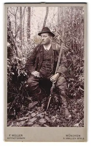 Fotografie F. Müller, München, Jäger Carl Baur mit Flinte hock im Wald auf der Lauer