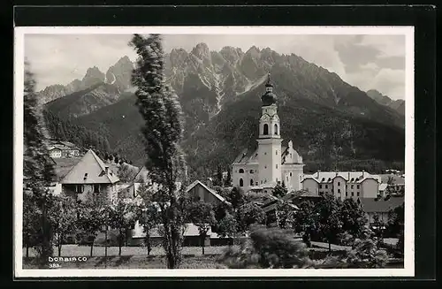 AK Dobbiaco, Blick auf die Kirche und die Berge dahinter