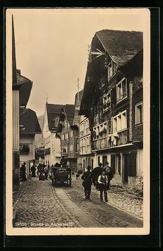 AK Andermatt, Fuhrwerk auf einer belebten Strasse