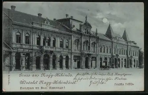 Mondschein-AK Nagy-Kikinda, Partie in der Hauptgasse, Häuserzeile mit Buchhandlung Radak