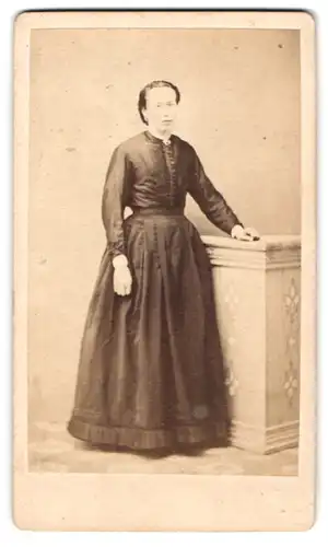 Fotografie unbekannter Fotograf und Ort, Portrait Frl. Anna Döpfer im schlichten dunklen Kleid stehend an einem Podest
