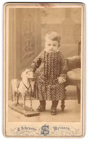 Fotografie Ernst Schroeter, Meissen, Kleinkind im karierten Kleid mit Spielzeug Pferd im Atelier