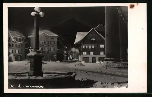 AK Dornbirn, Marktplatz mit Brunnen bei Nacht im Winter