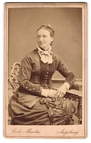 Fotografie Gebr. Martin, Augsburg, Dame im gerafften Kleid mit geflochtenen Haaren