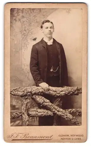 Fotografie J. F. Beaumont, Oldham, Park Road, Portrait junger Mann im Anzug am Holzgeländer stehend