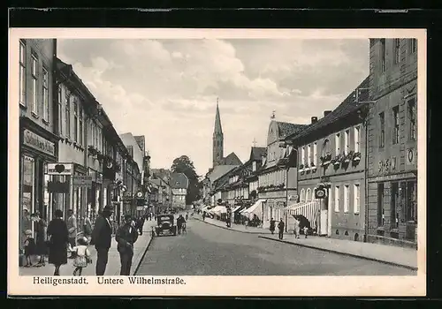 AK Heiligenstadt, Untere Wilhlemstrasse mit Geschäften und Kirche