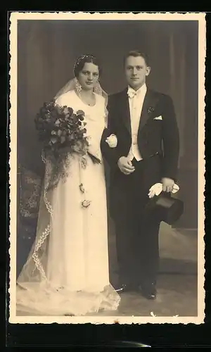 Foto-AK Junges Paar in Hochzeitskleidung mit Blumenstrauss