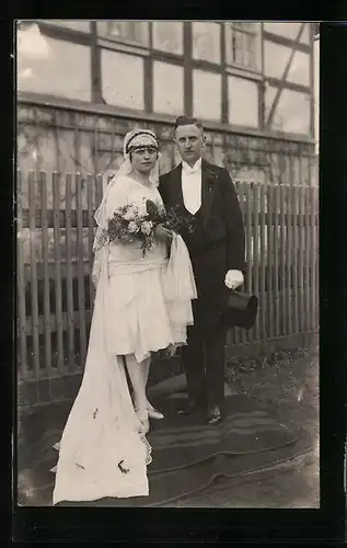 Foto-AK Junges Paar in Hochzeitskleidung mit Blumenstrauss