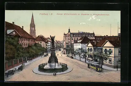 AK Freiburg i. B., Kaiser Wilhelmplatz mit Kaserne und Kriegerdenkmal, Strassenbahn