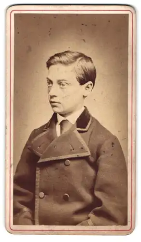 Fotografie G. Offinger, Weinheim, Kleiner Junge im Mantel schaut mit aufmerksamen Blick zur Seite