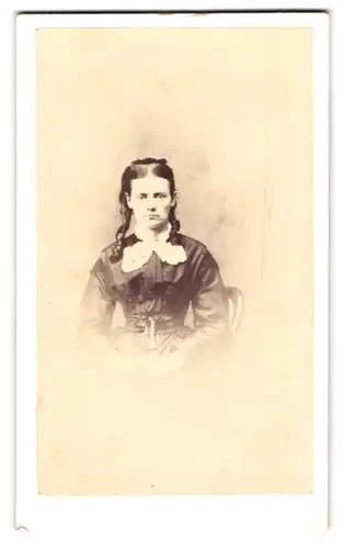 Fotografie C. Yardley, Lutterworth, Frau mit ernster Mimik und Zöpfen