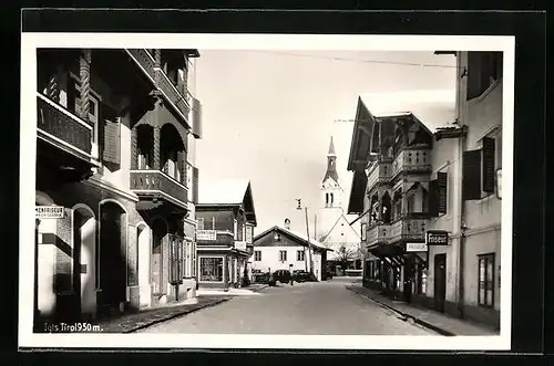 AK Igls, Strassenpartie mit Geschäften und Kirche