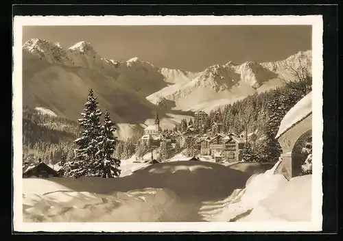 AK Arosa, Ortsansicht mit Kirche im Schnee