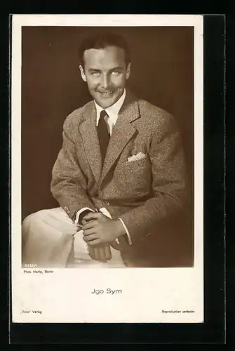 AK Schauspieler Igo Sym mit gekreuzten Beinen