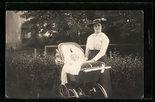 AK Mutter steht neben ihrem Kinderwagen mit dem Baby darin