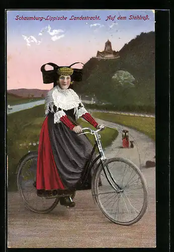 AK Frau in Tracht Schaumburg-Lippe auf einem Fahrrad