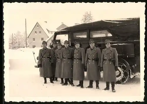 Fotografie Bundesheer Österreich, Soldaten neben Lastwagen mit Schneeketten im Winter